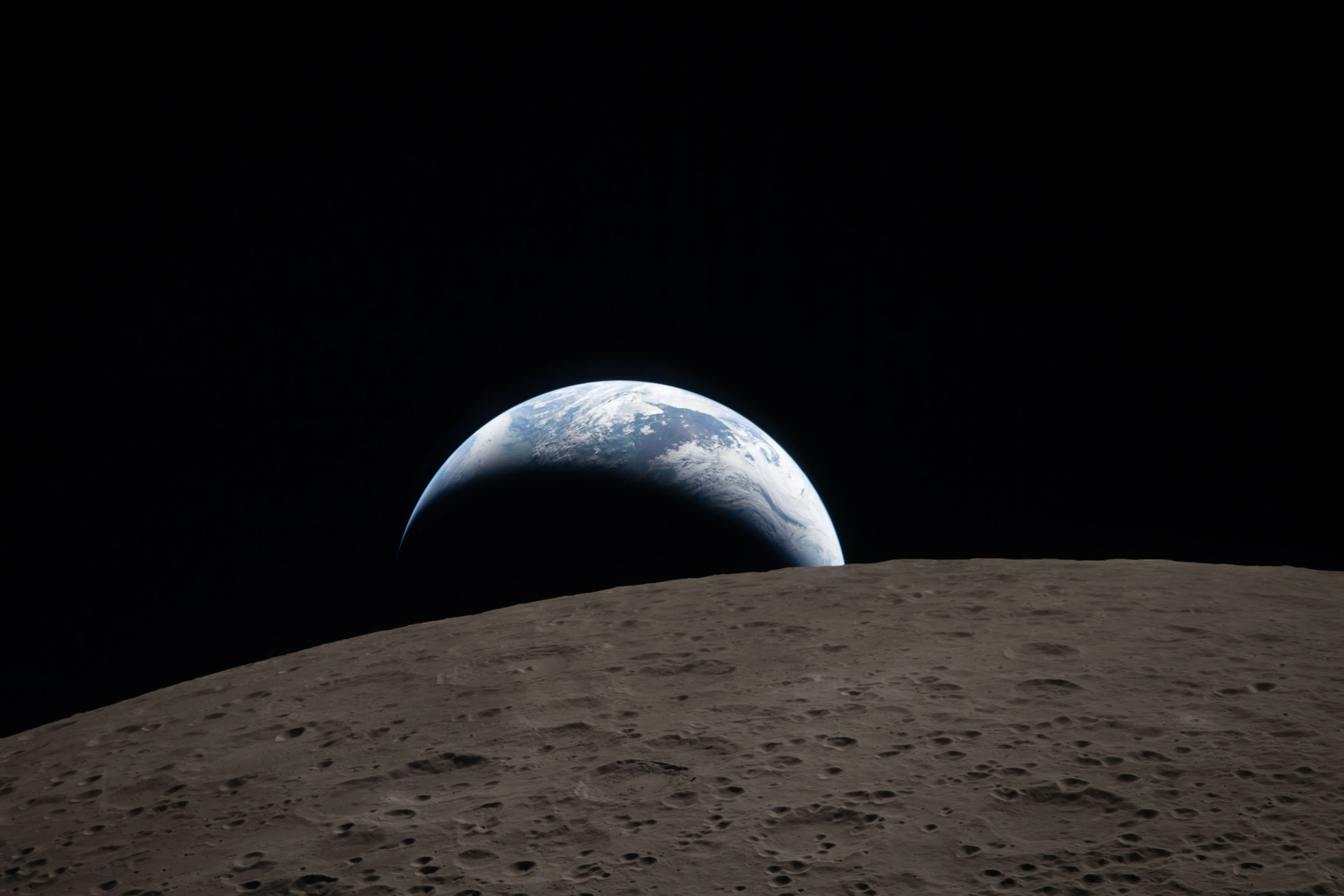 The Artemis II crew captured this view of Earth setting on April 6, 2026, as they flew around the Moon. As the astronauts flew over the Moon’s far side, the crew photographed and described terrain features including impact craters, ancient lava flows, and surface cracks and ridges formed as the Moon slowly evolved over time.