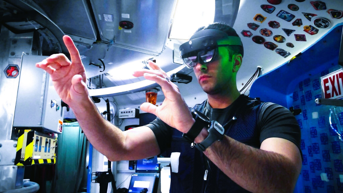 A research volunteer uses augmented reality goggles to perform astronaut-like tasks during a simulated space mission. Participants selected for NASA’s first Moon and Mars Exploration Analog mission also will perform tasks in immersive, interactive environments while living inside habitats that simulate traveling to and living on the Moon and Mars. Credit: NASA
