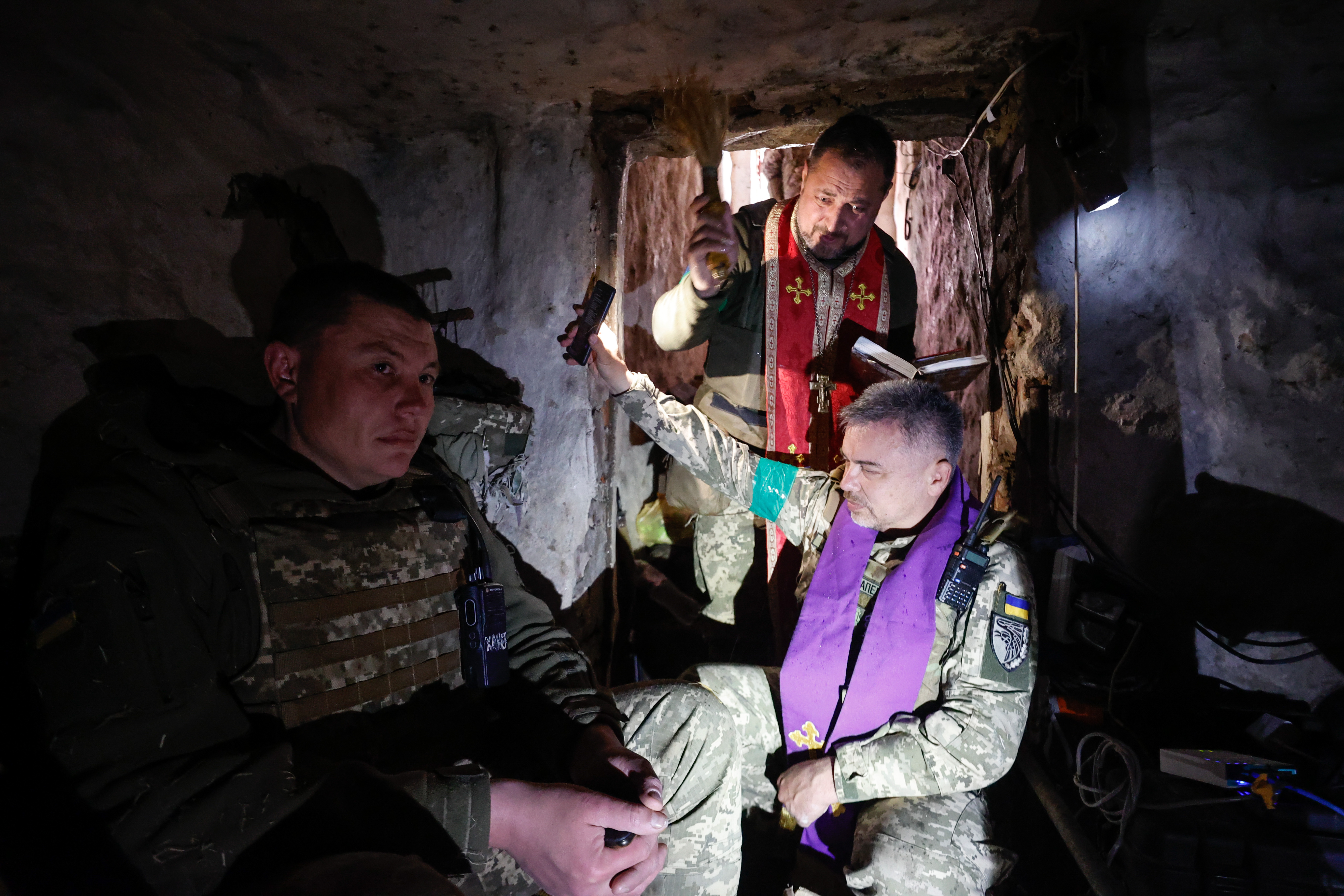 A religious service underway inside a Ukrainian bunker near the front line.