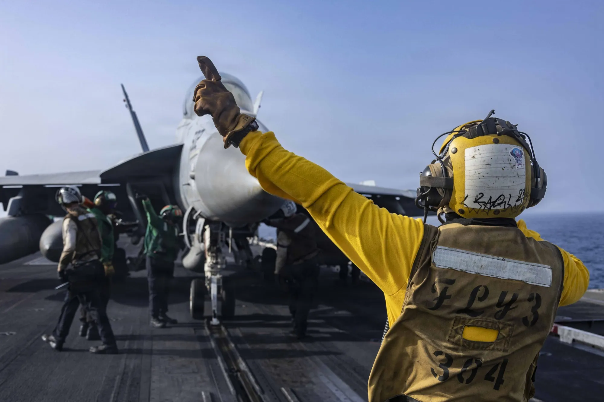 A fighter jet prepares to launch from the flight deck of USS Abraham Lincoln on June 25. Source: US Navy