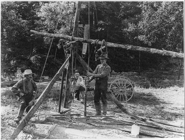 Petroleum exploration technologies have evolved from ancient “spring poles” to steam-powered percussion cable tools, to modern rotary rigs with steerable, diamond bits that can drill miles deep. Depicted in this photo, a “spring-pole” well that discovered oil when drilling for brine in Appalachia. Photo from “The World Struggle for Oil,” a 1924 film by the U.S. Department of the Interior. Source: https://aoghs.org/technology/oil-well-drilling-technology/