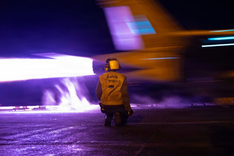 USS George H.W. Bush (CVN 77) Conducts Night Flight Operation. A U.S. Sailor conducts flight operations aboard Nimitz-class aircraft carrier USS George H.W. Bush (CVN 77), July 29, 2026. George H.W. Bush is deployed to the U.S. 5th Fleet area of operations to support maritime security and stability in the Middle East. (U.S. Central Command photo)