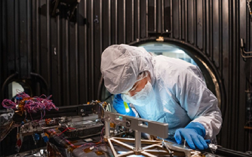 Mechanical Engineer Brie Ludwig inspects the Lunar Environment Monitoring Station (LEMS), a compact, autonomous, and self-sustaining seismometer suite designed to carry out continuous, long-term monitoring of the lunar seismic environment at the South Polar region. NASA/Denny Henry. Source: https://science.nasa.gov/missions/artemis/nasa-completes-astronaut-deployed-science-instrument-for-lunar-surface/