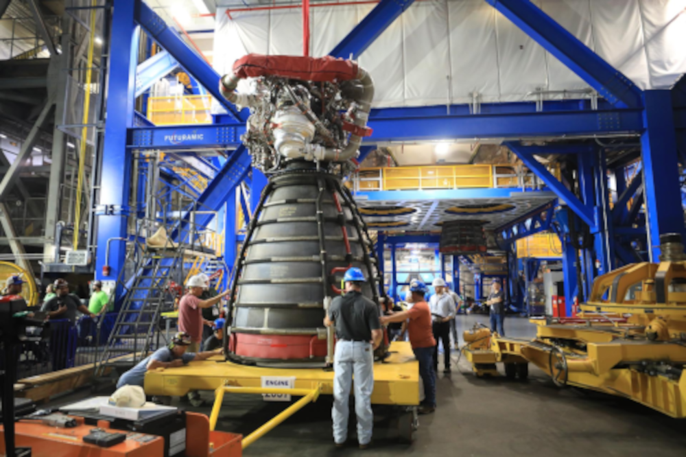 NASA Starts Artemis III Engine Install. Boosters, Crew Training Advance. Technicians prepare to transfer the #2 RS-25 SLS (Space Launch System) rocket engine (front) to the work stand with the #3 engine (back) for integration with the Artemis III core stage rocket on Tuesday, Aug. 25, 2026, inside the Vehicle Assembly Building at NASA’s Kennedy Space Center in Florida. NASA/Clayton Rougelot. Source: https://www.nasa.gov/blogs/missions/2026/08/27/nasa-starts-artemis-iii-engine-install-boosters-crew-training-advance/