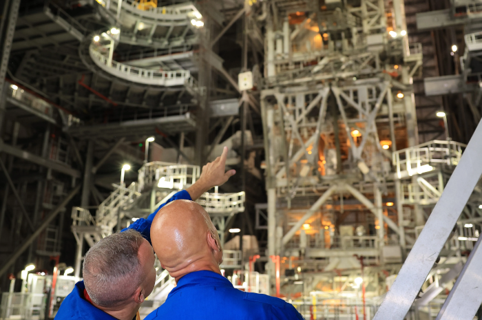 NASA astronaut Randy Bresnik (left) and ESA (European Space Agency) astronaut Luca Parmitano view progress on the solid rocket booster integration in High Bay 3 inside the Vehicle Assembly Building at NASA’s Kennedy Space Center in Florida on Wednesday, Sept. 2, 2026. Image credit: NASA/Kim Shiflett. Source: https://www.nasa.gov/image-article/artemis-iii-crew-visits-nasa-kennedys-vehicle-assembly-building/
