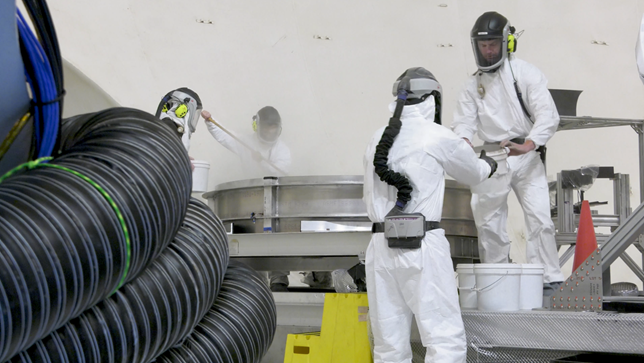 To help NASA and commercial partners better understand the science of lunar landings, a crew loads simulated lunar dirt into the test bin in a 60′ vacuum sphere. (NASA/Rob Lorkiewicz) Source: https://www.nasa.gov/missions/artemis/nasa-begins-moon-mission-plume-surface-interaction-tests/