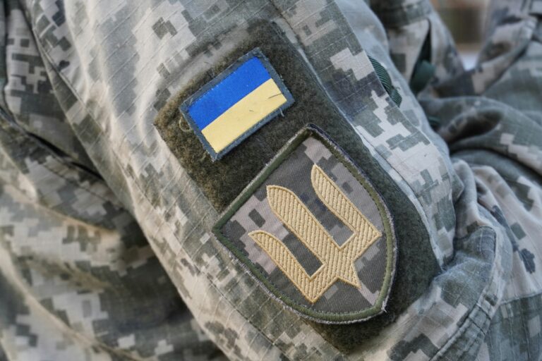 Ukraine's trident symbol patch on a soldier's camouflage uniform. Photo from Ukraine by Žilvinas Ka on Unsplash, @zilvinaska. Published on June 17, 2022 (UTC) SONY, ILCE-6400. Free to use under the Unsplash License
